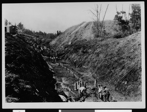 Slauson Avenue storm drain construction, showing a grassy hill in the background