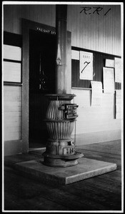 Interior view of the East Side Railroad Station, showing a potbelly stove, December 1, 1917