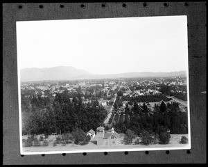 View of Riverside, showing buildings separated from the main residential area by rows of trees, ca.1910