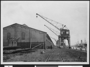 Cranes on wharf used to load ships, ca.1920