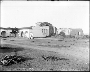 View of the mission bells next to the old stone church from the southeast corner of the mission grounds, Orange County, California, ca.1900