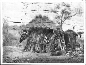 Havasupai women making baskets in front of a dwelling in Havasu or Cataract Canyon, ca.1900