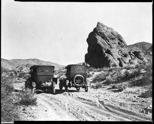 Two cars on the road to Death Valley north of Barstow