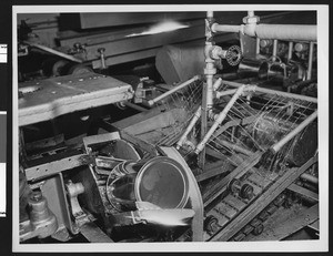 Interior of a canning factory, showing detail view of machinery, ca.1935