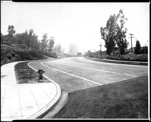 View of Silverlake Boulevard, looking southwest from Dillon Street, showing a highrise building in the background, 1932