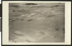 Aerial view of flooding of the Santa Ana River, showing flooding over fields, ca.1930