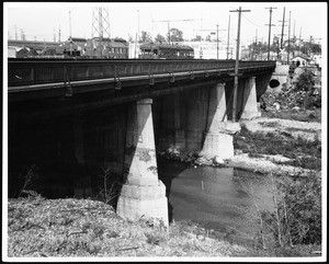 Close-up view of an electric car traveling across the Aliso Street Bridge over the Los Angeles River, May 1940