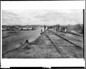 Flood damage to the Santa Fe tracks on the old Downey Avenue Bridge (later North Broadway) during the Los Angeles flood of 1885-1886