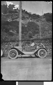 Mr. Hays of the northwestern division of Great Western Power Company sitting in an automobile on the Napa-Suisun Line, ca.1910