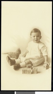 A portrait of an infant with toys