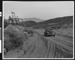 Automobile in the canyon from which Darwin gets its water, Death Valley, ca.1900-1950