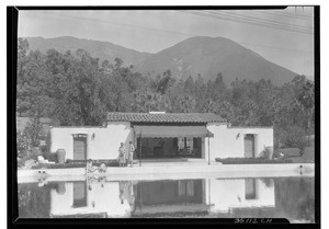 People in front of a pool house at the Arrowhead Springs Hotel resort near San Bernardino, ca.1925-1930