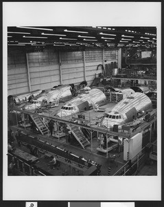 Three metal-plated nose-ends of the Lockheed Constellation aircrafts at a factory assembly line, ca.1943-1958