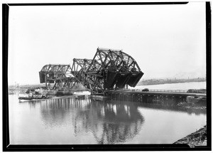 Bascule Bridge opening over the Los Angeles Harbor with boat passing under, July 30, 1929