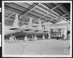 Several DC-2 tail ends in an aircraft assembly line, 1934