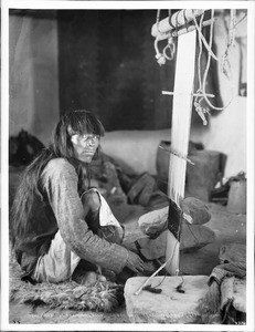 Hopi man weaving a kochina sash for a ceremonial kilt, Arizona, ca.1898