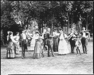 Portrait of six couples of "La Jota" Spanish dancers in various poses led by Jose Rivera, 1910