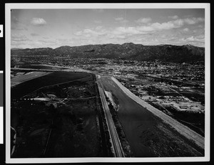 View of the flooded Los Angeles River, showing the Griffith Park airport, 1938