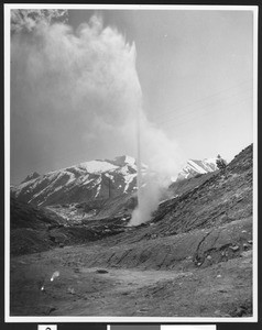 Geyser amidst a dirt slope