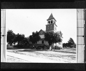 Exterior view of the Friends Church in Whittier showing a horse-drawn carriage in front of the building, ca.1900