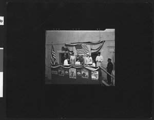 Group of people behind a counter selling government war bonds during World War II, ca.1941-1945