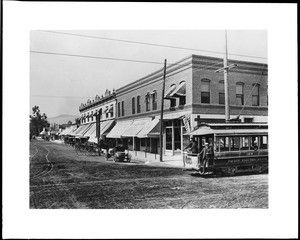 View of the corner of Citrus Avenue and Badillo Street in Covina, showing a Pacific Electric streetcar, ca.1908