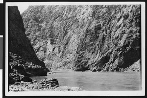 Construction of Boulder Dam, showing a river between mountains, ca.1930