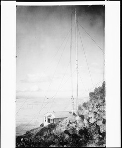 Unidentified house on an ocean cliff