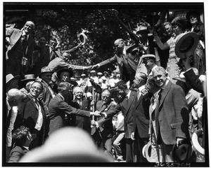 "Wedding of the rails", showing men shaking hands over the railroad tracks, 1926