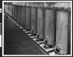 Water heaters (?) in an unidentified factory interior, ca.1950