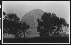 View of Morro Rock through trees, San Luis Obispo, ca.1900