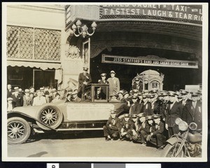 People posing in front of the Warner Brothers Theater in Hollywood before 1937 for the opening of the movie, "Taxi," starring James Cagney and Loretta Young