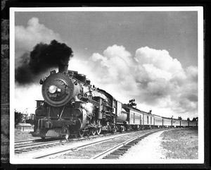 Steam locomotive pulling a long line of cars