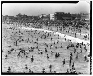 Beachgoers wading in the surf at an unidentified beach, ca.1926