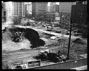 Steam shovel digging a hole during the construction of City Garage in Pershing Square, Los Angeles, 1951