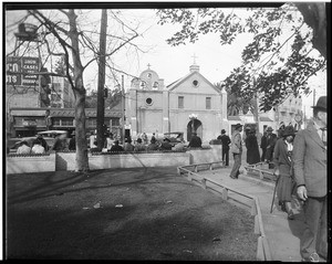 People in a park across the street from the Plaza Church, Los Angeles, ca.1910