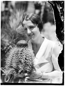 Smiling woman holding a cactus in the Natural History Museum