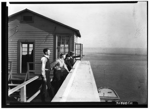 Four men outside of the observation room at the Marine Exchange, 1904 (1924?)