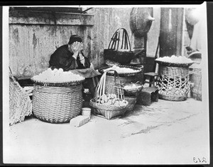 A woman operating a fruit stand