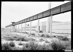 Exterior view of the Federal Prison at Los Angeles Harbor, showing watch towers