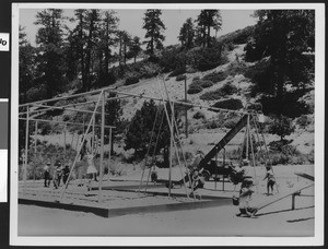 Children on swings and other playground equipment at Big Pines, ca.1930