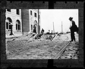 View of Mission Street in San Francisco, showing twisted streetcar tracks and other earthquake damage, 1906