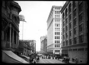 View of Sixth Street east from Hill Street showing several large buildings, 1909