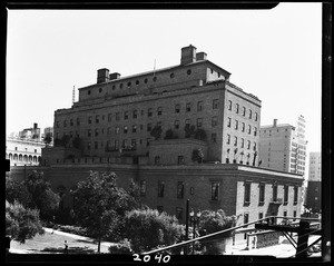 California club, showing person and trees near base of building