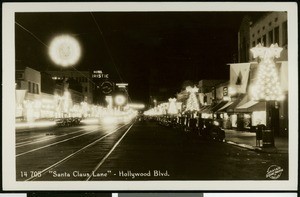 View of Hollywood Boulevard decorated as "Santa Claus Lane" at night, 1936