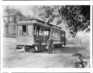 Portrait of two streetcar conductors with their streetcar on Ninth and Grand View Avenue, Los Angeles, ca.1900