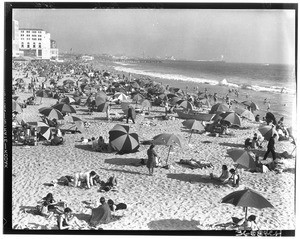 People under umbrellas on Venice Beach