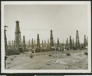 Oil wells, showing derricks in desert terrain, ca.1930