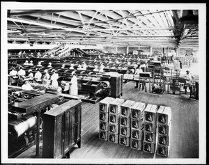 Interior of a citrus packing house, showing crates of fruit ready to be shipped, ca.1930