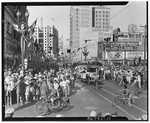 Parade for Charles Lindbergh, passing the Chamber of Commerce building, showing men on bicycles and motorcycles, September 20, 1927